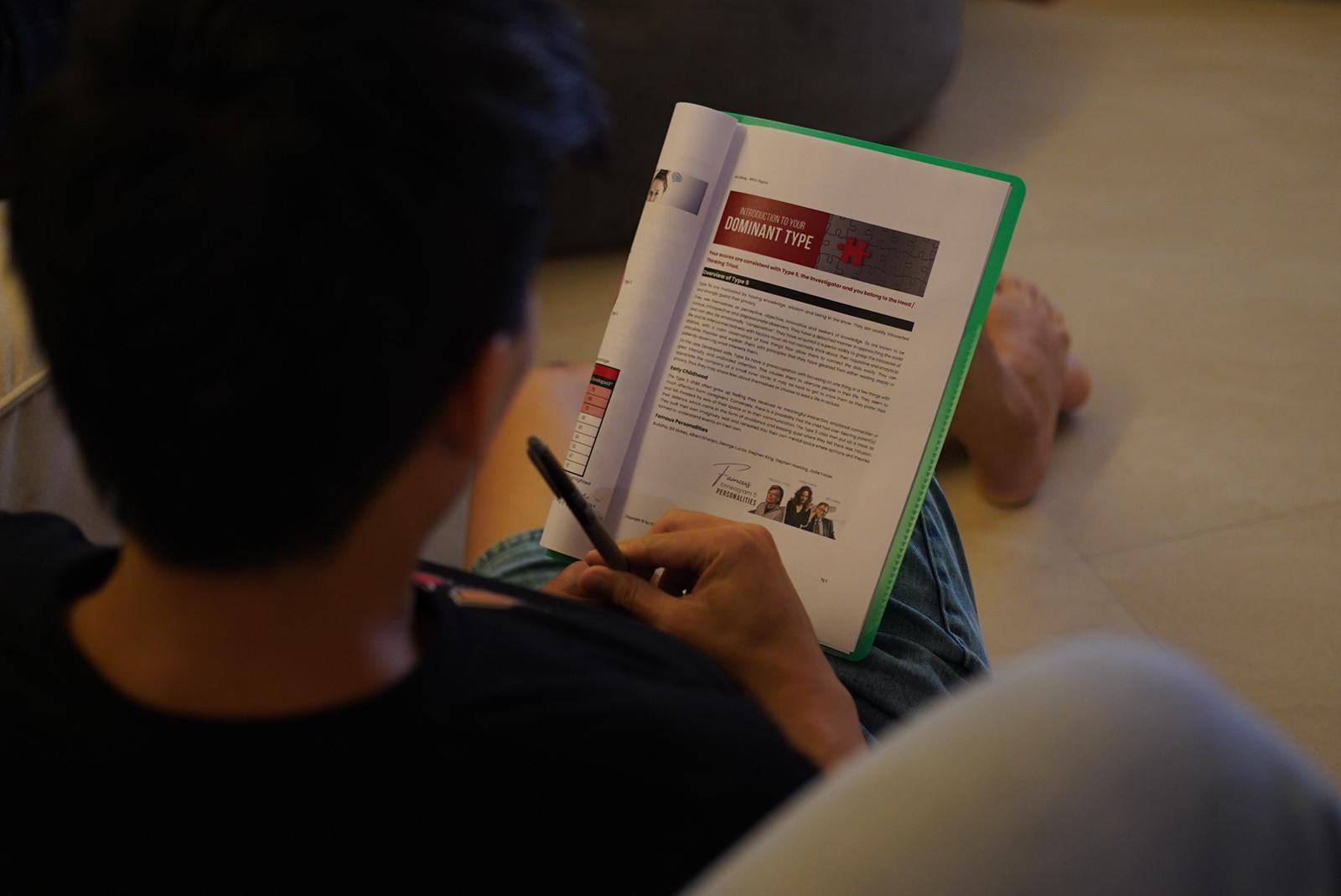 A participant reading their Enneagram type workbook